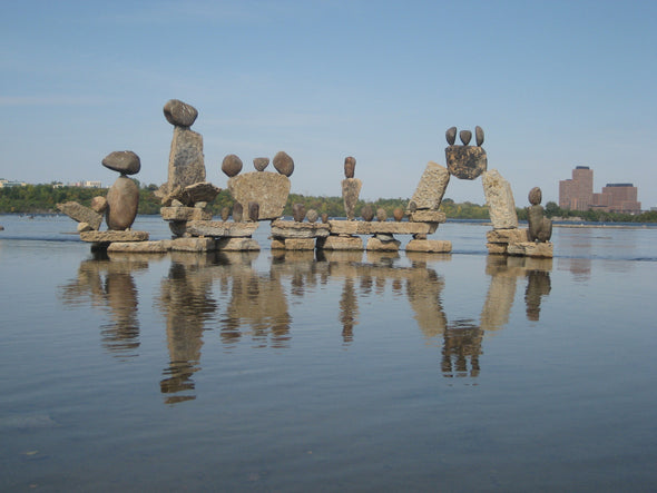 rocks balancing on one another to create a free-standing structure in the ottawa river