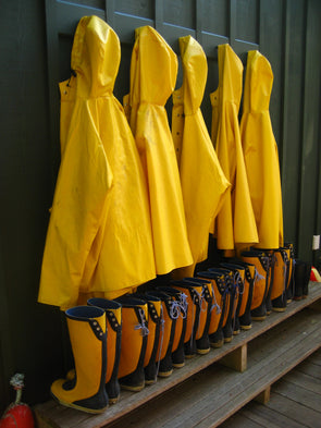 Yellow raincoats and boots hanging and ready when needed