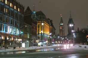 Elgin Street in Ottawa, Ontario lite up at night with a view of Parliament in the background
